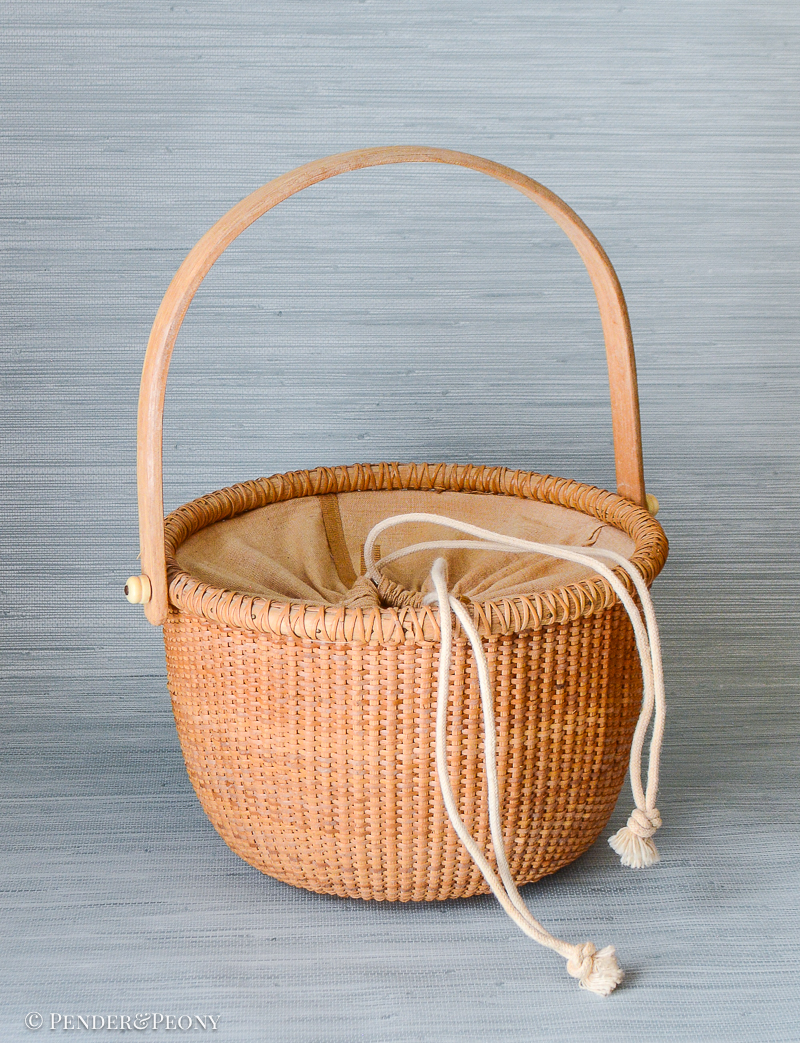 A New England classic basket with handle and cloth lining.