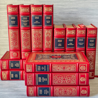 A Victorian bibliophile’s dream set in stunning red and navy leather with lavish gilt detailing.
