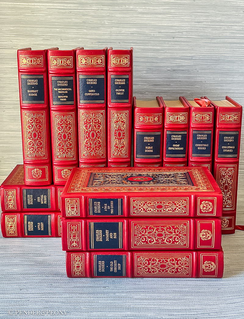 A Victorian bibliophile’s dream set in stunning red and navy leather with lavish gilt detailing.