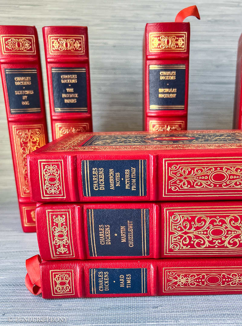A Victorian bibliophile’s dream set in stunning red and navy leather with lavish gilt detailing.