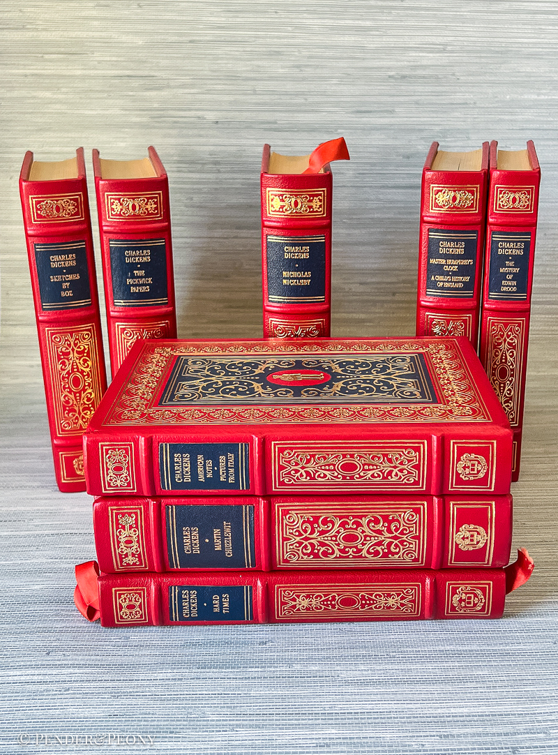 A Victorian bibliophile’s dream set in stunning red and navy leather with lavish gilt detailing.