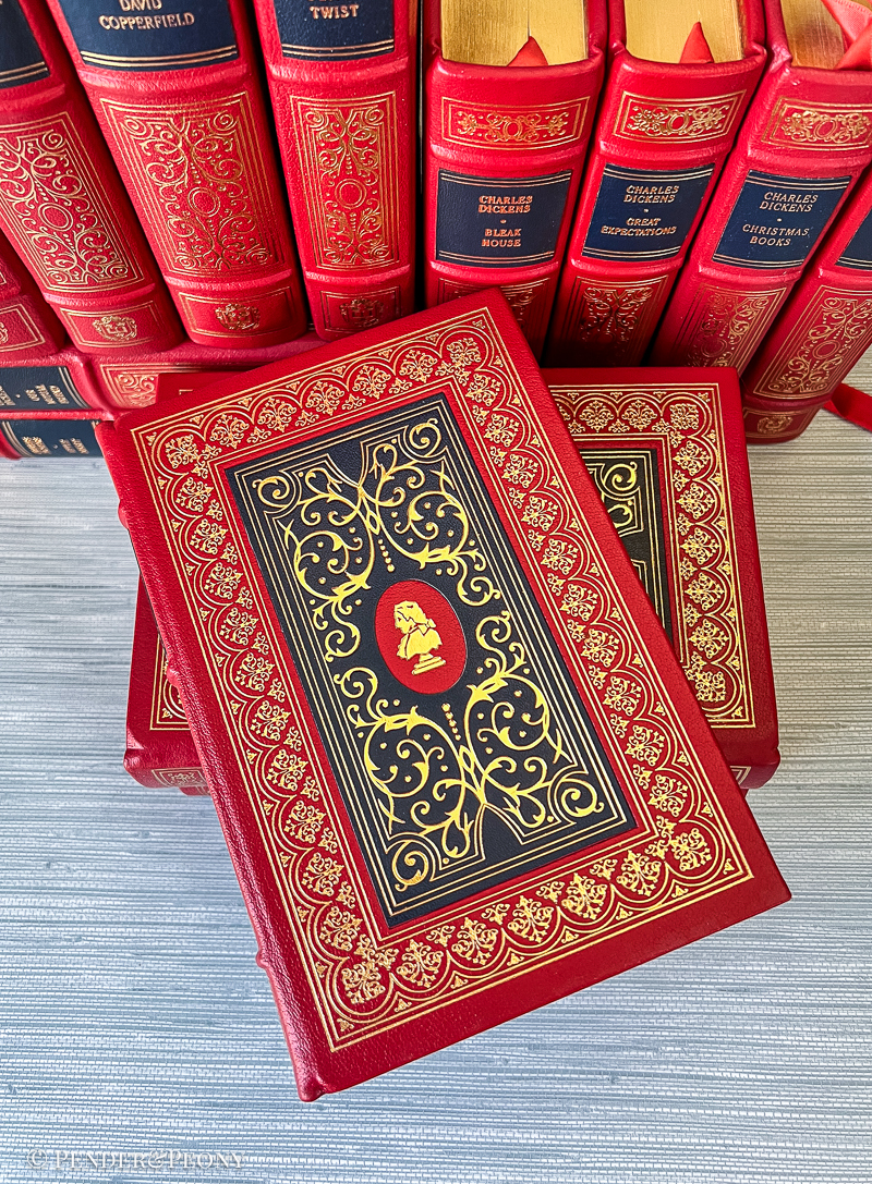 A Victorian bibliophile’s dream set in stunning red and navy leather with lavish gilt detailing.