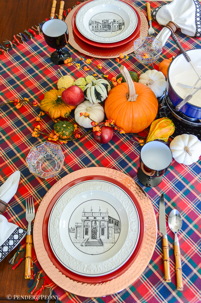 Fall fondue party tablescape set with plaid throw, Mottahedeh creil dishes, copper, Swissmar fondue pot, and Murano glass goblets.