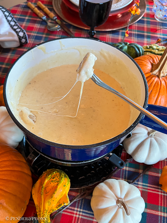 Dipping bread in fondue cheese with a Swissmar pot