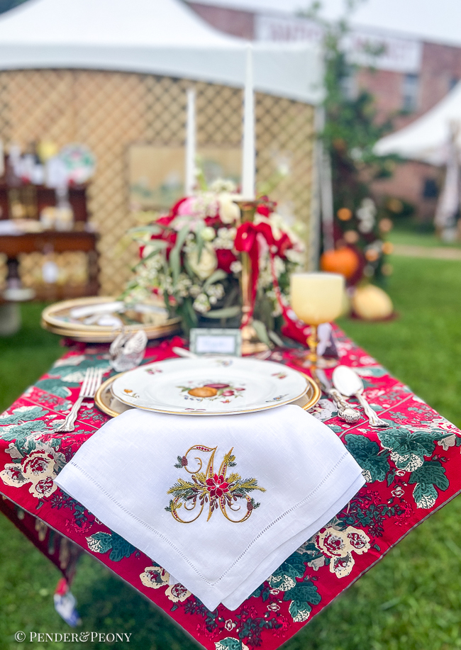 Monogrammed napkin from JKafie Studios embroidered with poinsettia and pinecones