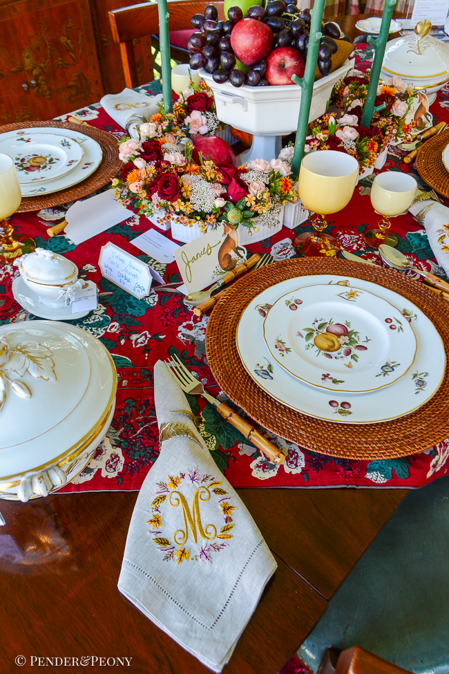 Elegant Thanksgiving tablescape with fruit and chintz theme, featuring Royal Worcester Delecta bone china, rattan, bamboo, Limoges, Moretti cased glass goblets, and red chintz linen