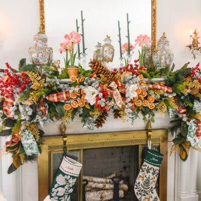 Christmas garland idea - Grand Botanical look for a lush Christmas garland on the mantel with magnolia, cedar, pine, red berries, dried oranges, gold fern, and sugar pine cones.
