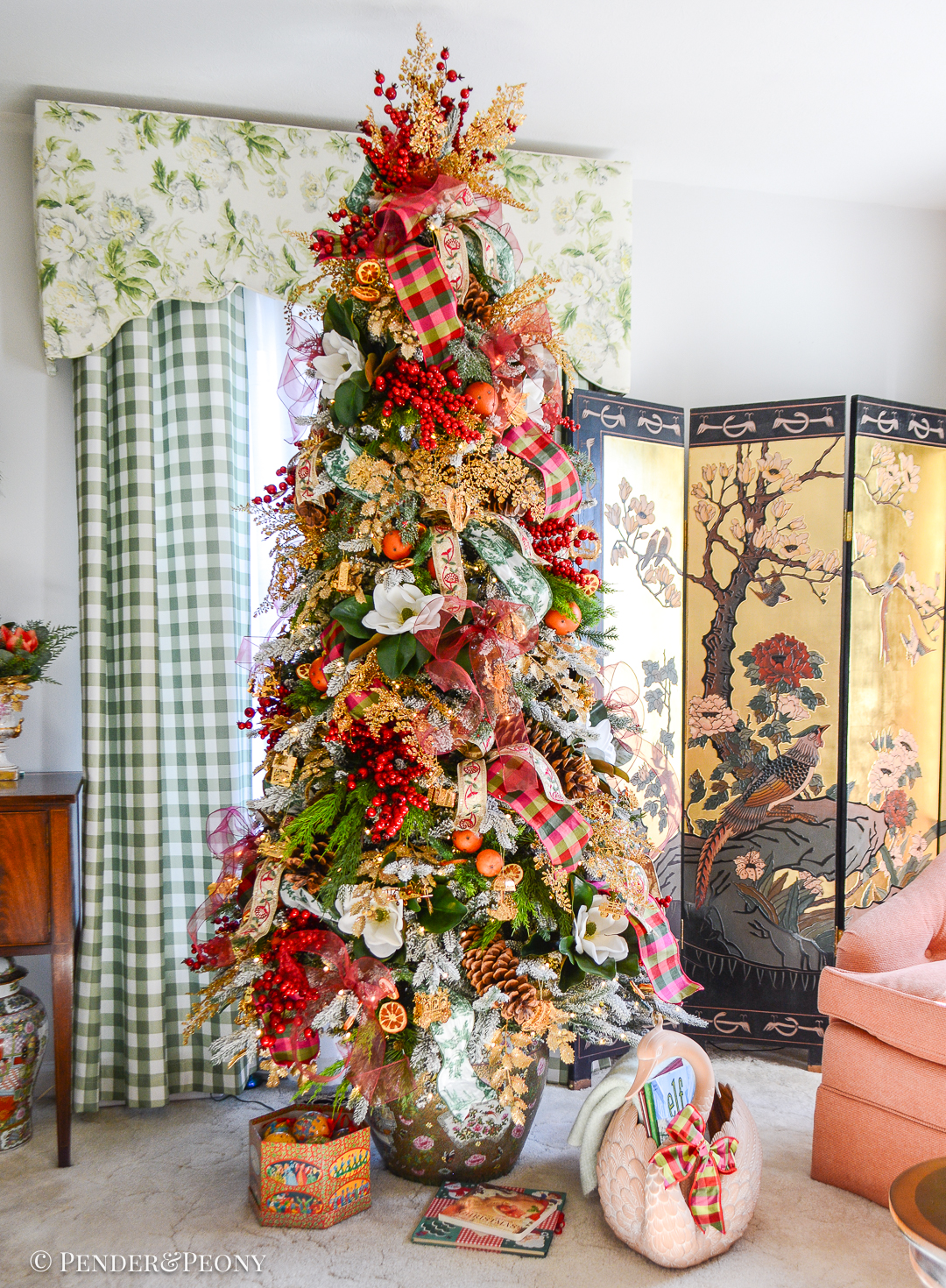 My Christmas tree decorated in the Grand Botanical look with a pink, green, and red color scheme, Danbury Mint gold ornaments, designer ribbons, bows, magnolia, orange pomanders, and joy!