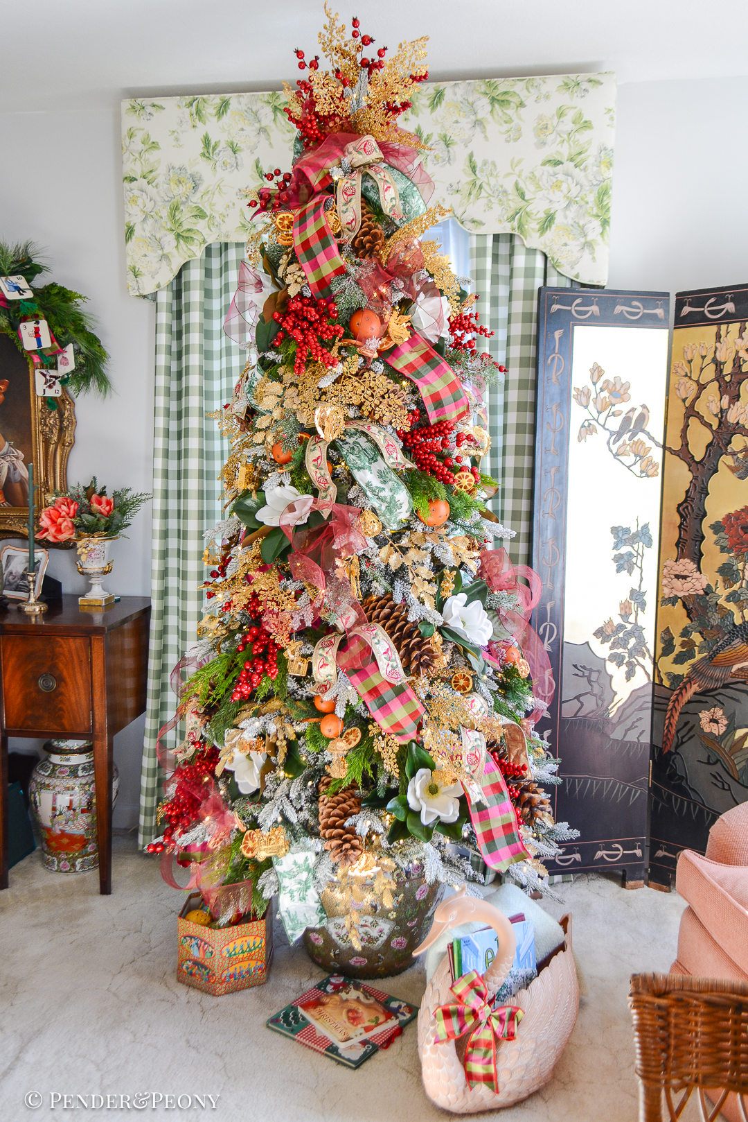 My Christmas tree decorated in the Grand Botanical look with a pink, green, and red color scheme, Danbury Mint gold ornaments, designer ribbons, bows, magnolia, orange pomanders, and joy!