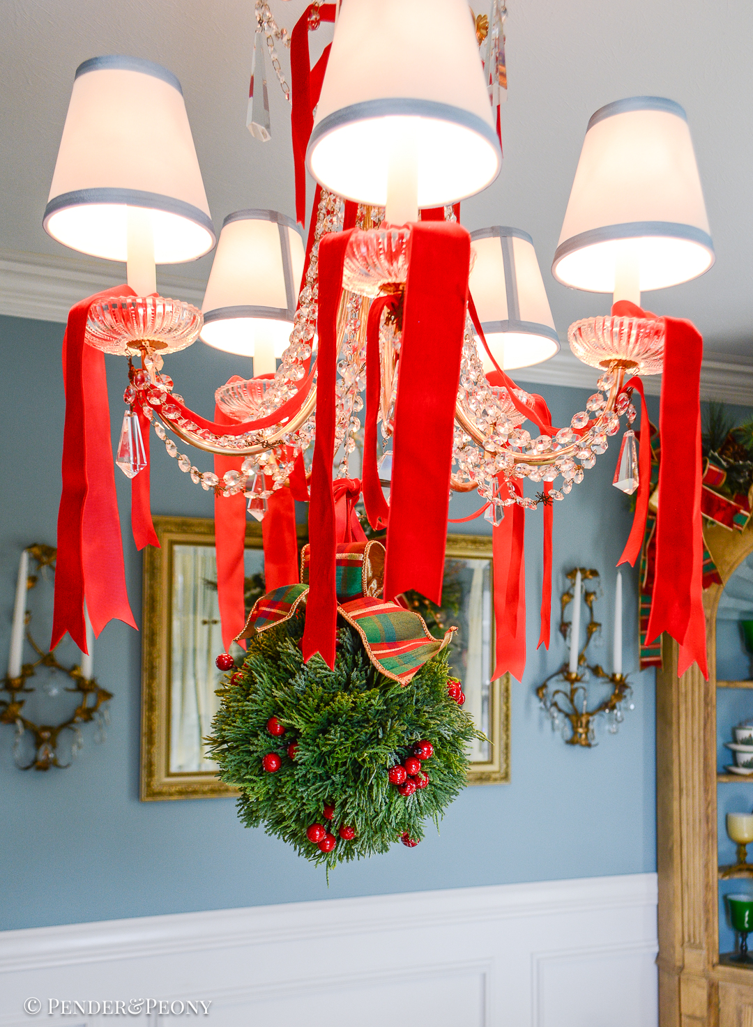Faux cedar kissing ball with red berries and plaid bow