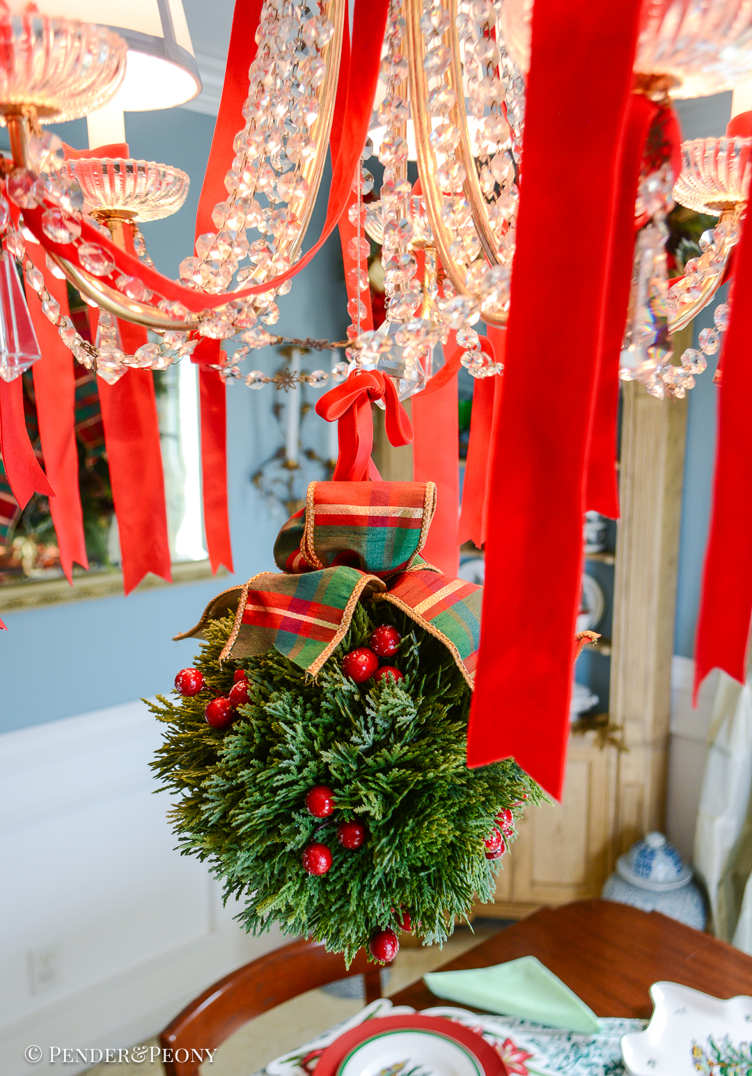 Faux cedar kissing ball with red berries and plaid bow