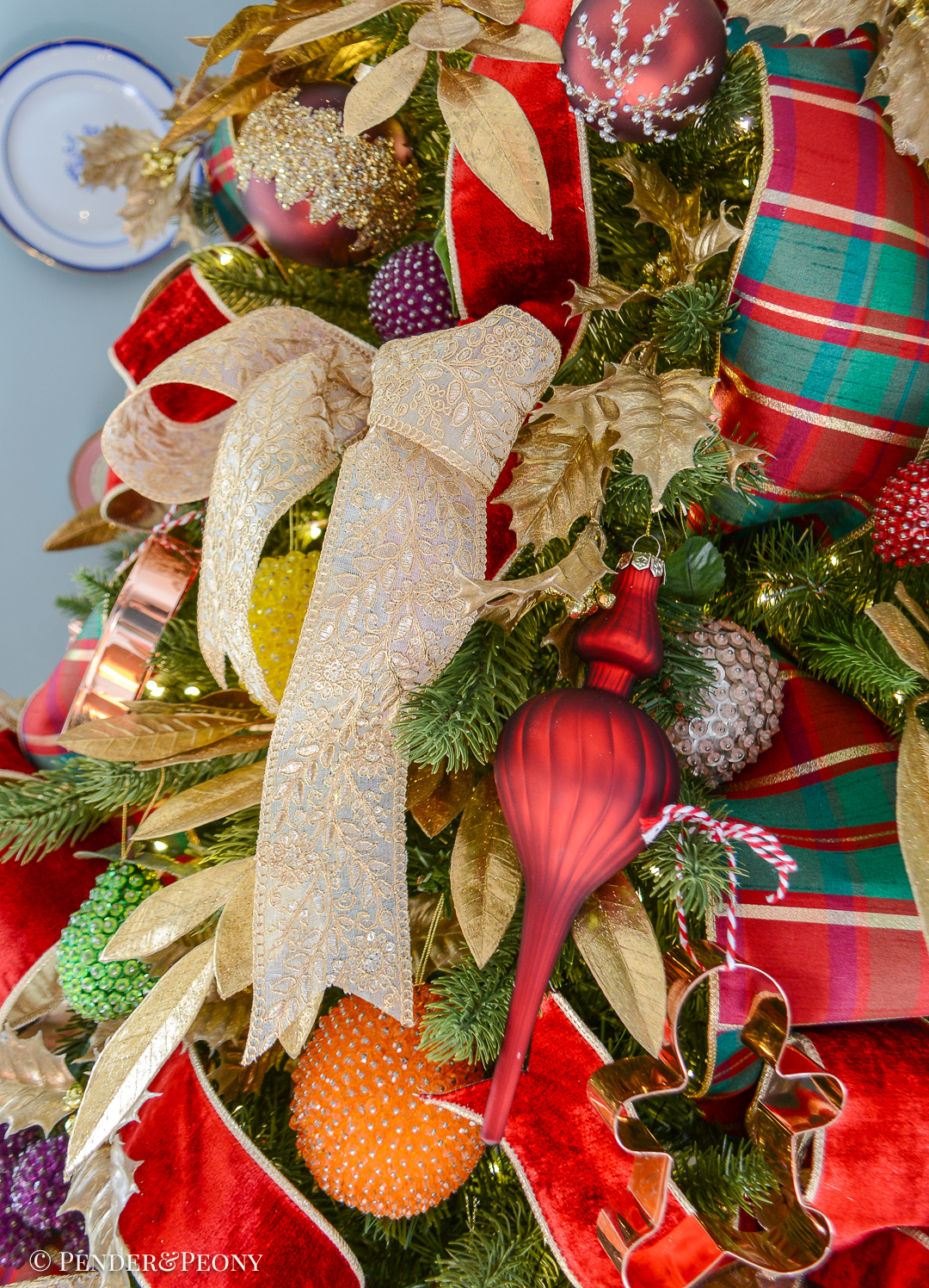 Gold embroidered ribbon tied in simple bow on Christmas tree
