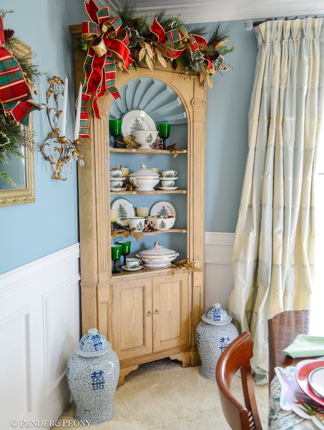 Spode's Christmas tree pattern dishes with antique French china and Murano glasses decorate the corner hutch