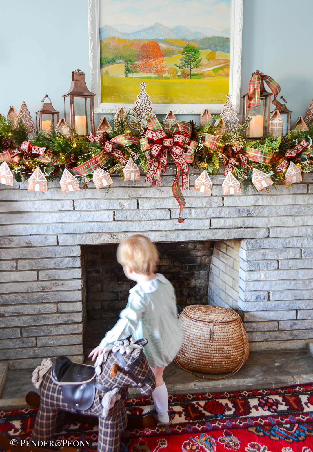 Come explore the fireplace Christmas decorations in our family room where a gingerbread village nestles amongst the holly and pine in this gorgeous garland idea