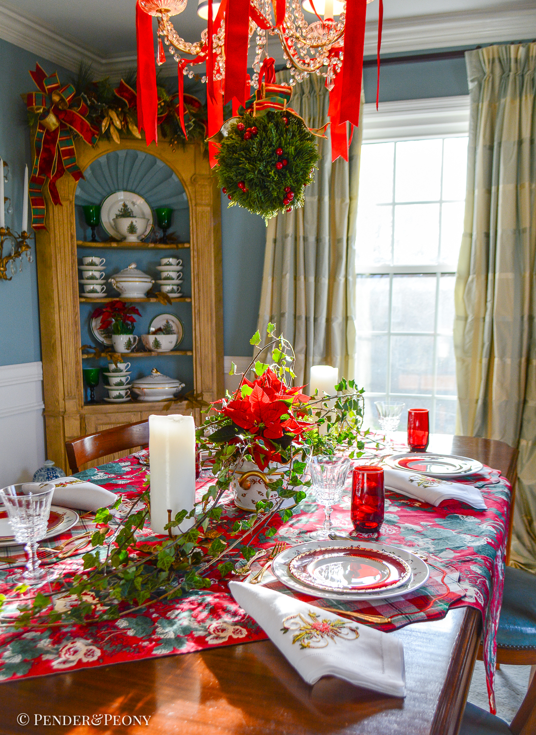 Christmas table setting with Johnson Bros 12 Days of Christmas plates, Royal Worcester salads, French crystal, and plaid placemat