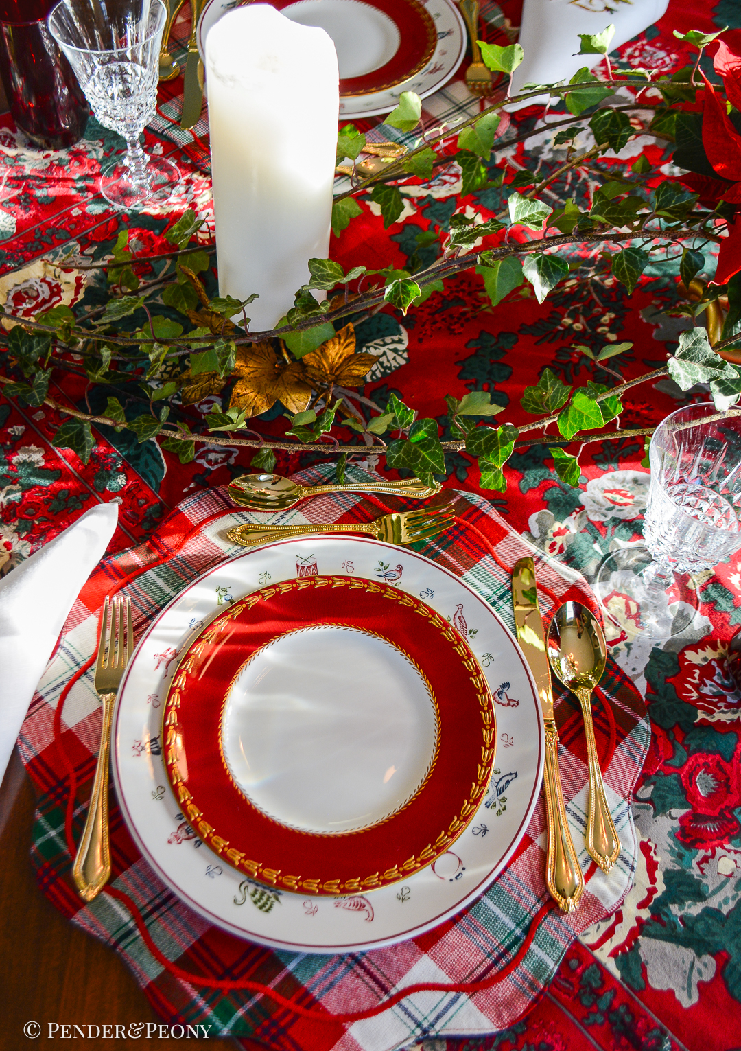 Christmas table setting with Johnson Bros 12 Days of Christmas plates, Royal Worcester salads, French crystal, and plaid placemat