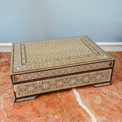 Large vintage dresser box with marquetry inlay of bone, mother of pearl, and a blue material. Red felt interior
