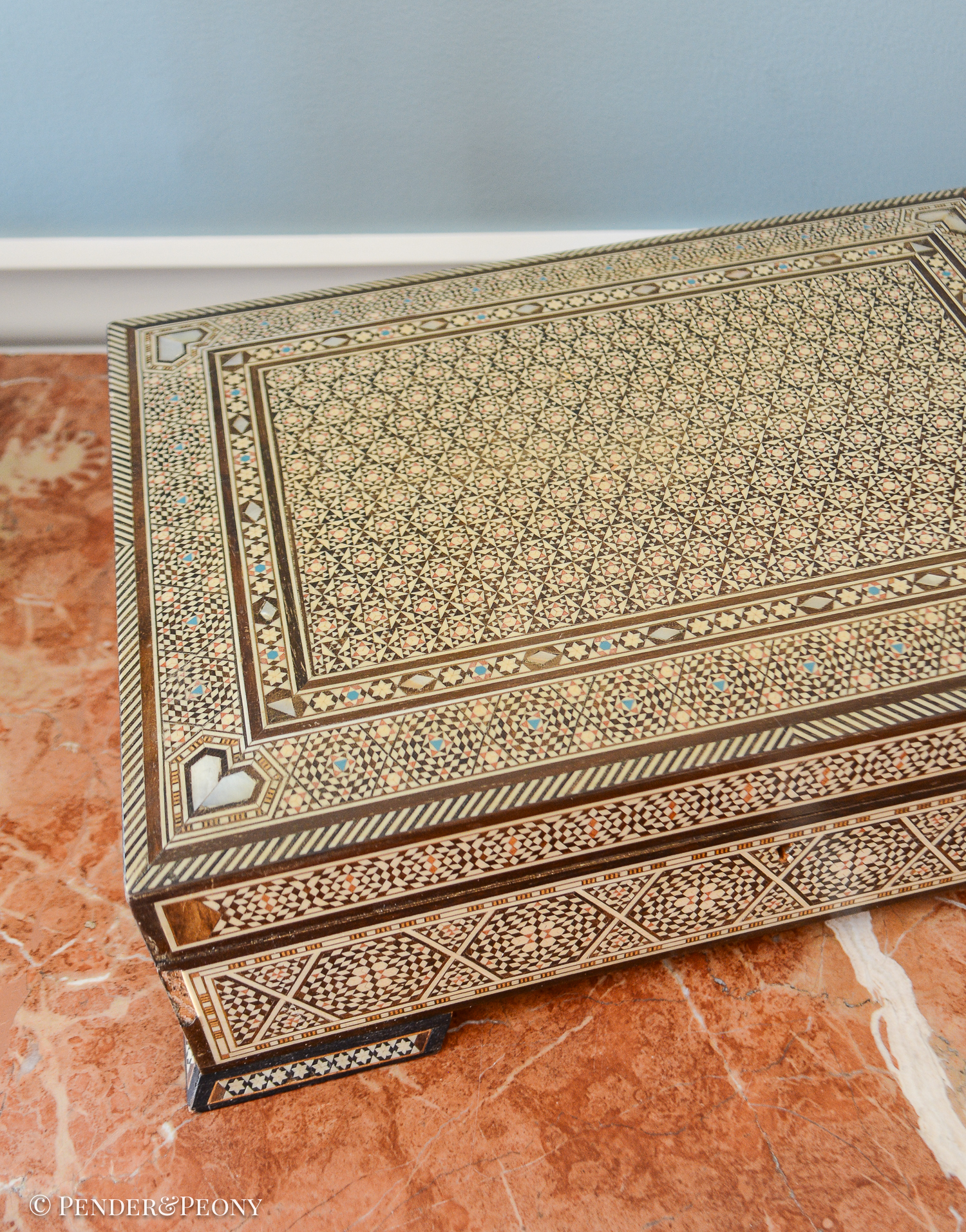 Large vintage dresser box with marquetry inlay of bone, mother of pearl, and a blue material. Red felt interior