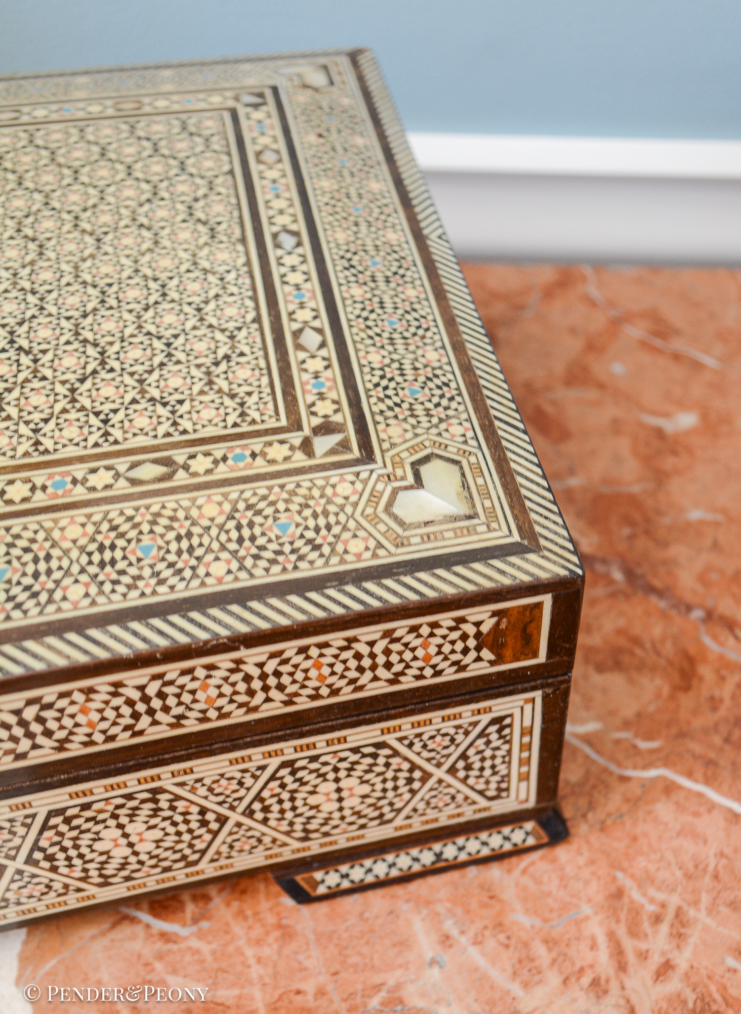 Large vintage dresser box with marquetry inlay of bone, mother of pearl, and a blue material. Red felt interior