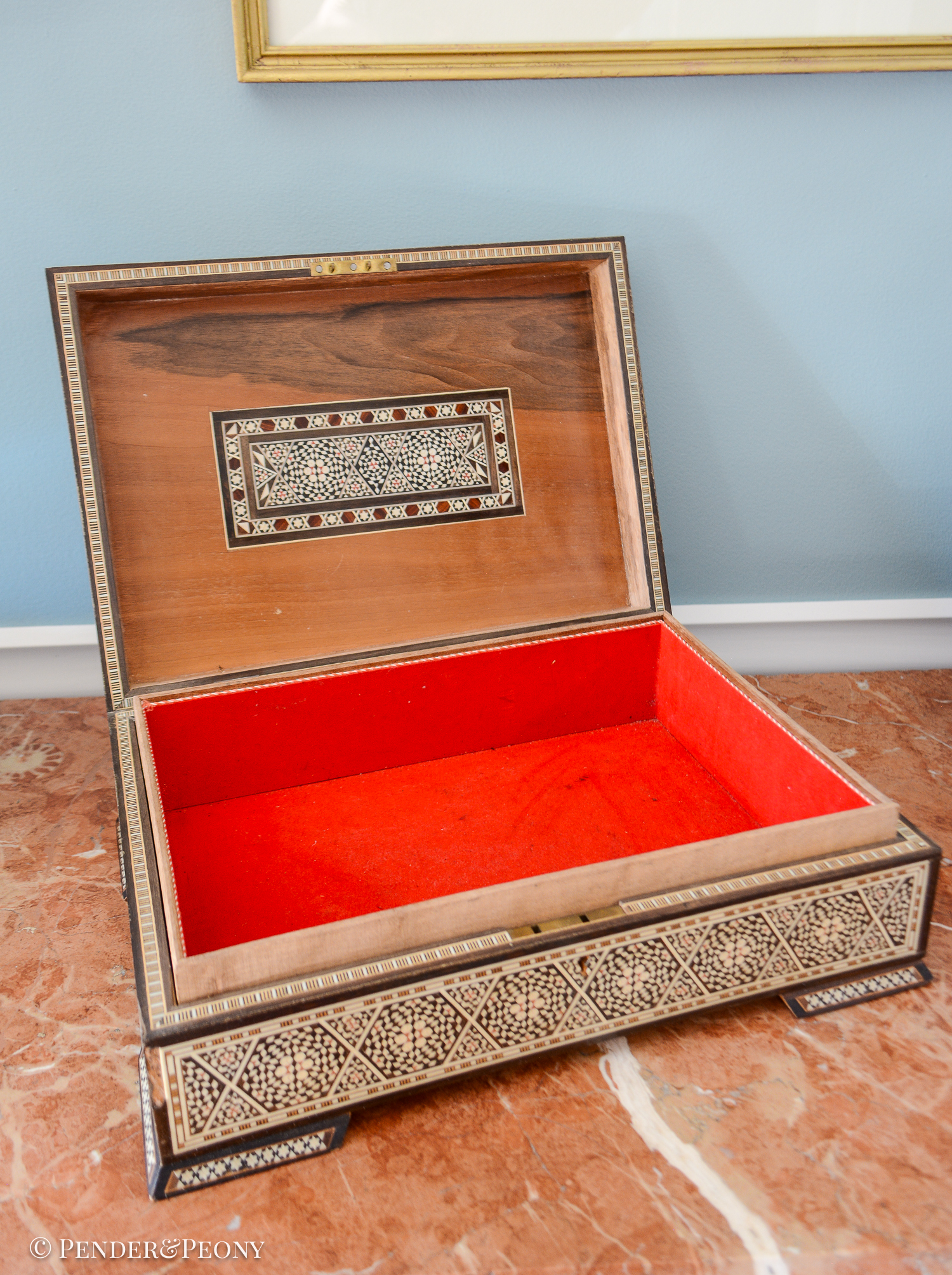 Large vintage dresser box with marquetry inlay of bone, mother of pearl, and a blue material. Red felt interior