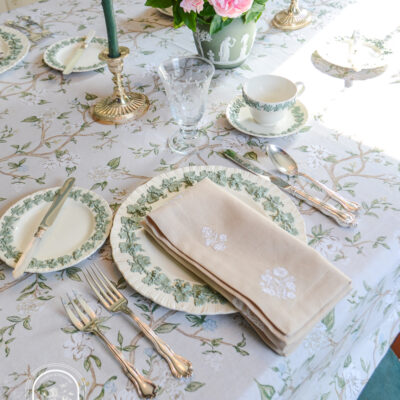 Spring table decor with Wedgwood Queen's Ware embossed dishes, embroidered floral linens, and antique silver