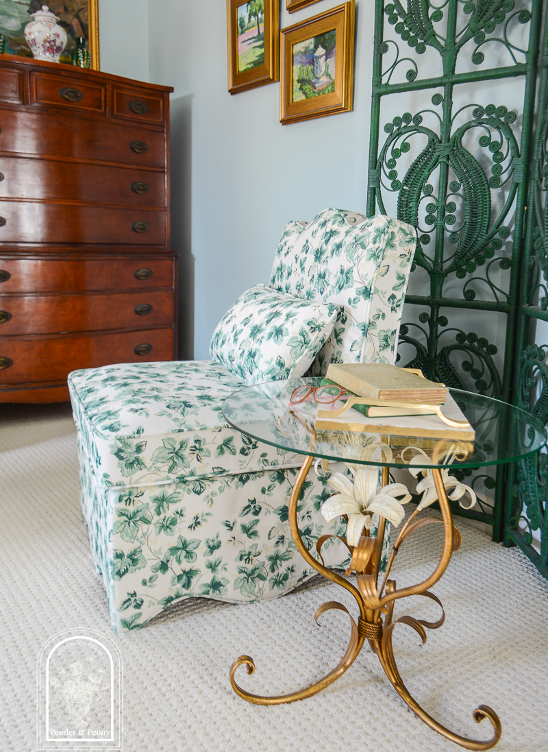 Slipper chair in green and white leaf fabric with vintage floral gilt table