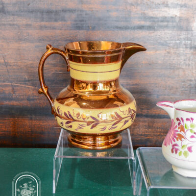 Copper lustre jug with yellow bands and vines