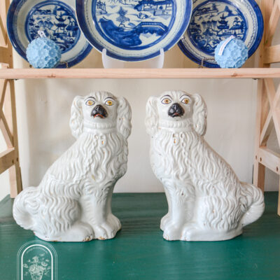 Pair of Staffordshire spaniels in white with black muzzles, yellow eyes, and some gilt detailing