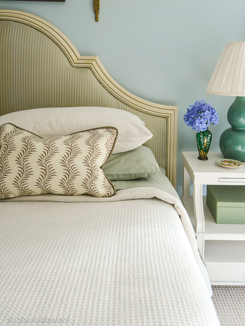 Bed in cream, sage, and brown, with hydrangeas on nightstand - small ways to cultivate beauty in your home: add fresh flowers