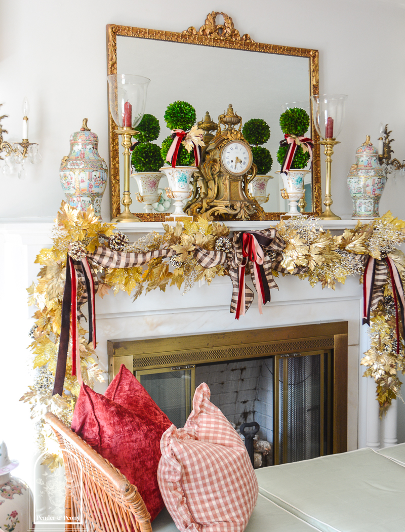 Elegant fall mantel garland in gold maple leaves with brown, pink, and burgundy bows