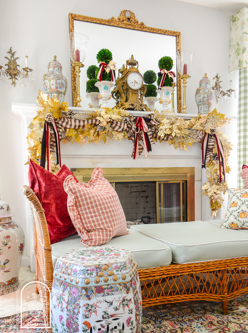Elegant fall mantel garland in gold maple leaves with brown, pink, and burgundy bows
