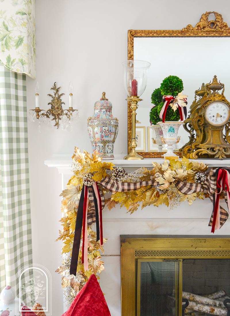 Elegant fall mantel garland in gold maple leaves with brown, pink, and burgundy bows