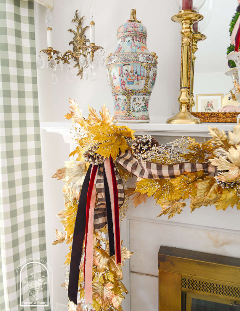 Gold maple leaf garland with brown, pink, and burgundy ribbon streamers