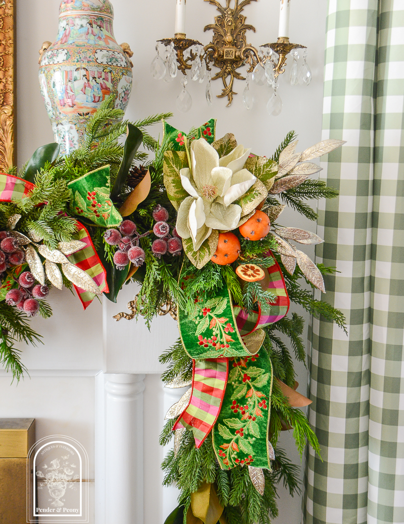 Glittered magnolia and laurel sparkle on this 2026 Christmas garland idea that blends traditional Colonial Williamsburg style with that Old World Christmas feel.