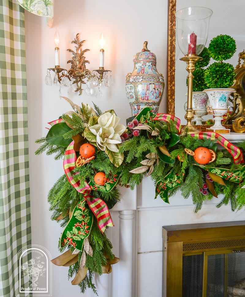 Glittered magnolia and laurel sparkle on this 2026 Christmas garland idea that blends traditional Colonial Williamsburg style with that Old World Christmas feel.