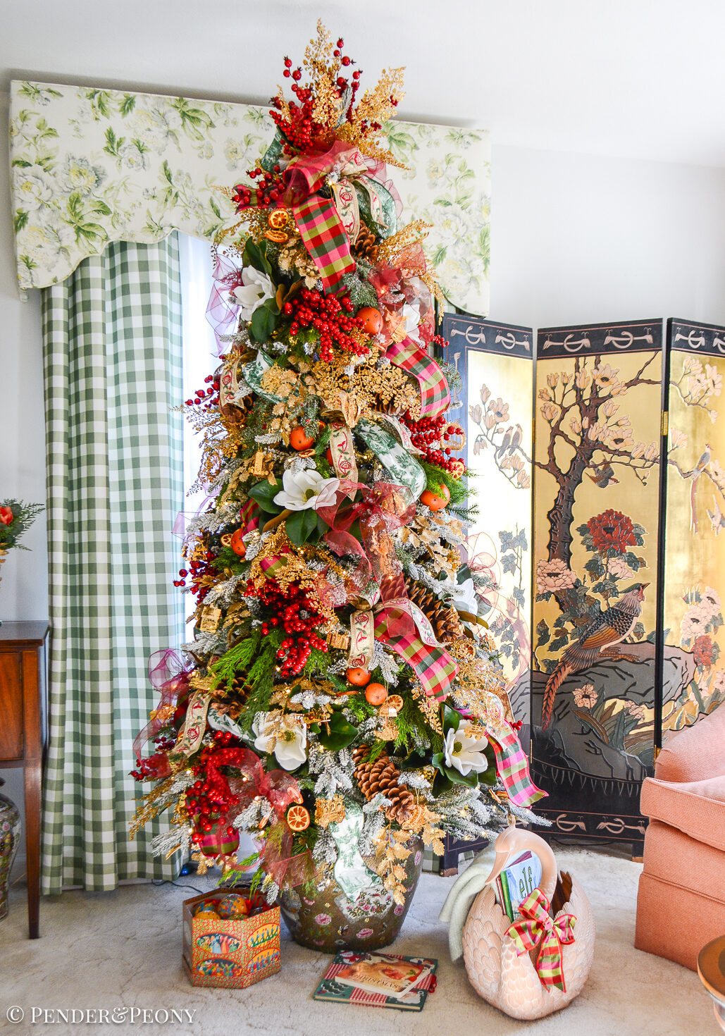 My Christmas tree decorated in the Grand Botanical look with a pink, green, and red color scheme, Danbury Mint gold ornaments, designer ribbons, bows, magnolia, orange pomanders, and joy!