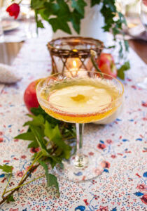 apple cider mimosa in an etched champagne coupe