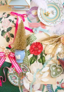 Georgian Chinoiserie Garden Christmas Decoration inspiration shown in flatlay, featuring camellia prints, Wedgwood, pink gingham, Rose Medallion, greek key trim, feathers, and velvet ribbon.