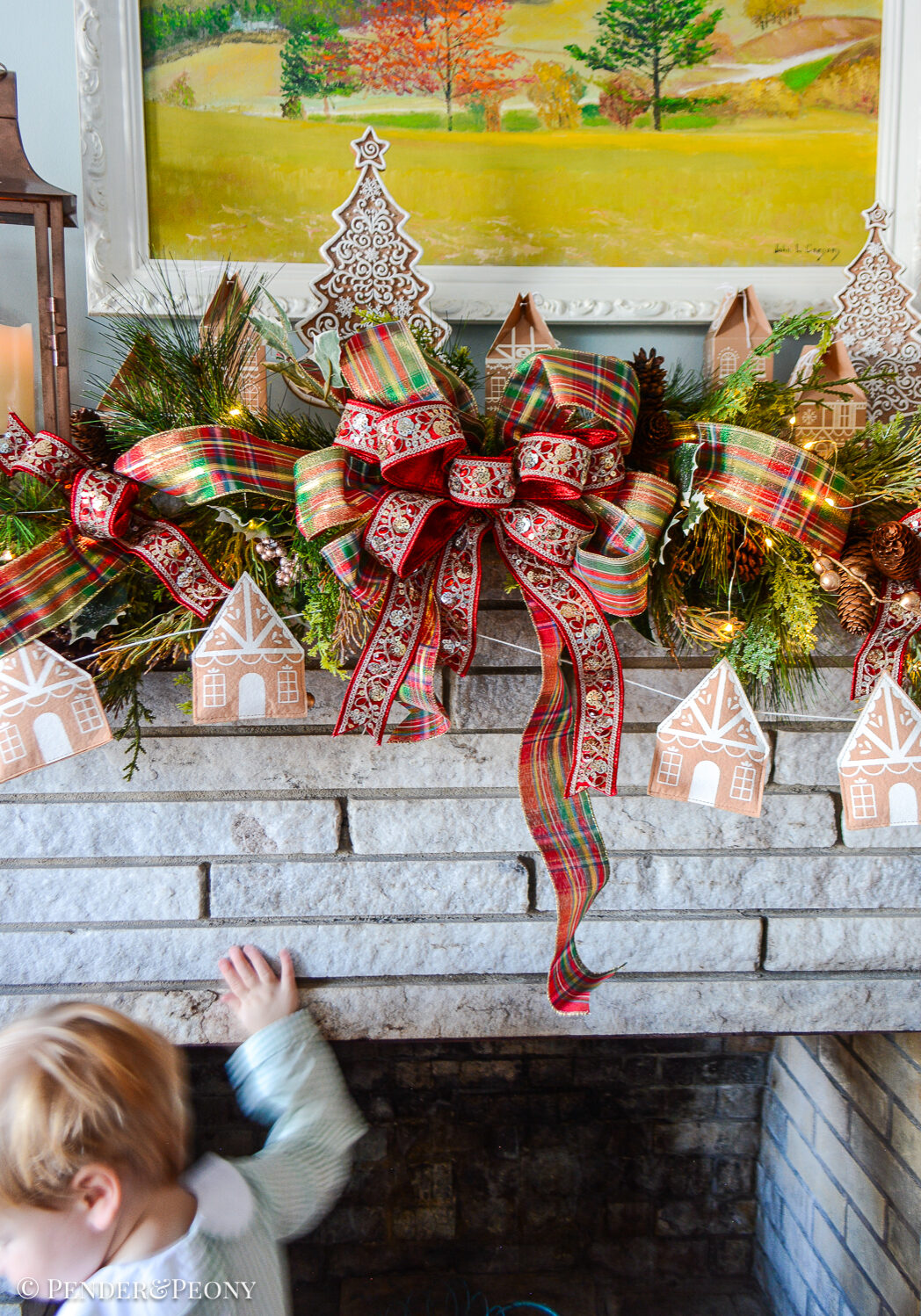 Come explore the fireplace Christmas decorations in our family room where a gingerbread village nestles amongst the holly and pine in this gorgeous garland idea