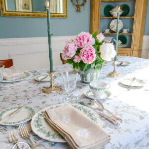 Elegant spring table decor with Wedgwood Queen's Ware, peonies, silver, and floral linens