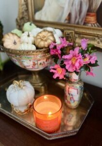 Pumpkin candle with pink camellias