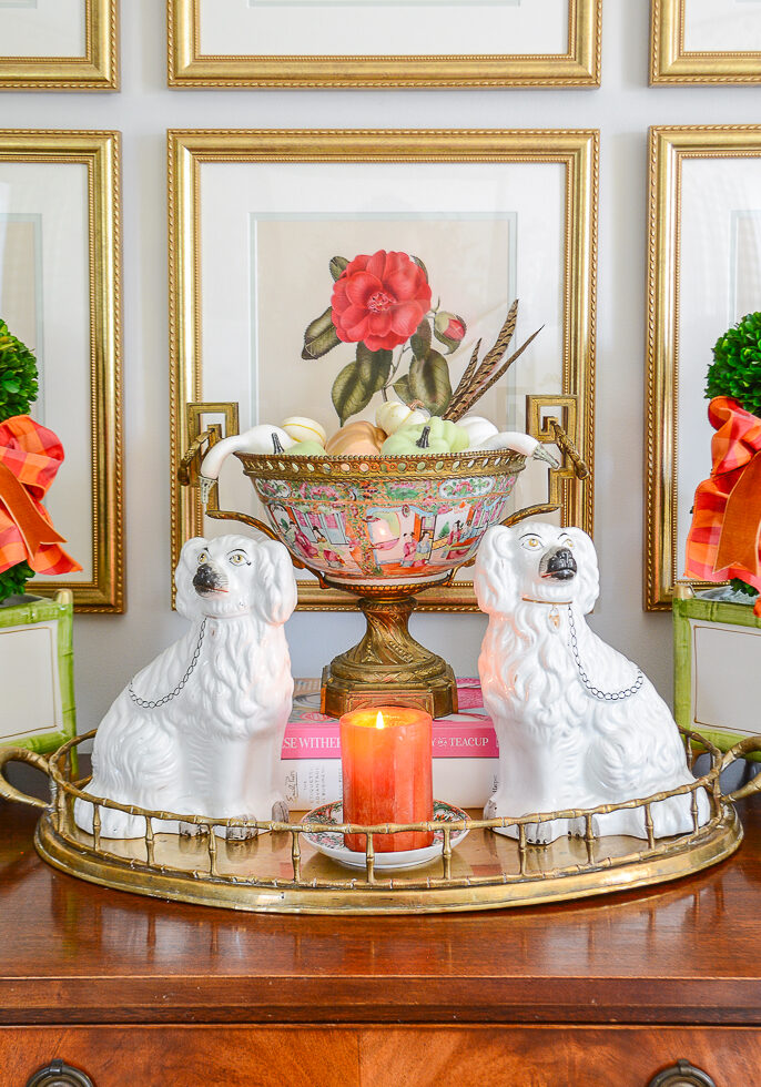 Fall decor in the living room with antiques, vintage brass, gingham ribbon, and pumpkins