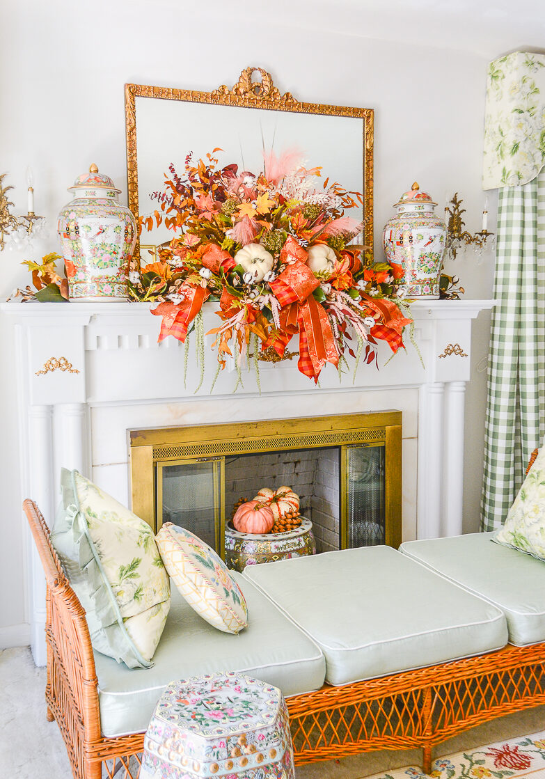 Fall mantel decor idea with sculptural garland full of autumn foliage and pumpkins