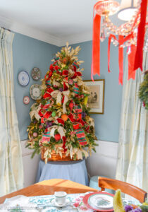 Dining room Christmas tree bedecked with vintage beaded fruit, plaid ribbon, gold laurel, and copper cookie cutters.