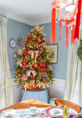 Dining room Christmas tree bedecked with vintage beaded fruit, plaid ribbon, gold laurel, and copper cookie cutters.