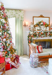 Christmas in my green and white living room with a Grandmillennial meet Williamsburg theme of pink and red, orange pomanders, magnolia, and antiques