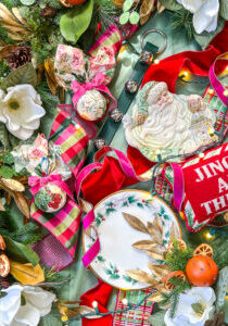 Grandmillennial meet Williamsburg Christmas look - flatlay of ribbon, ornaments, dishes, and decor