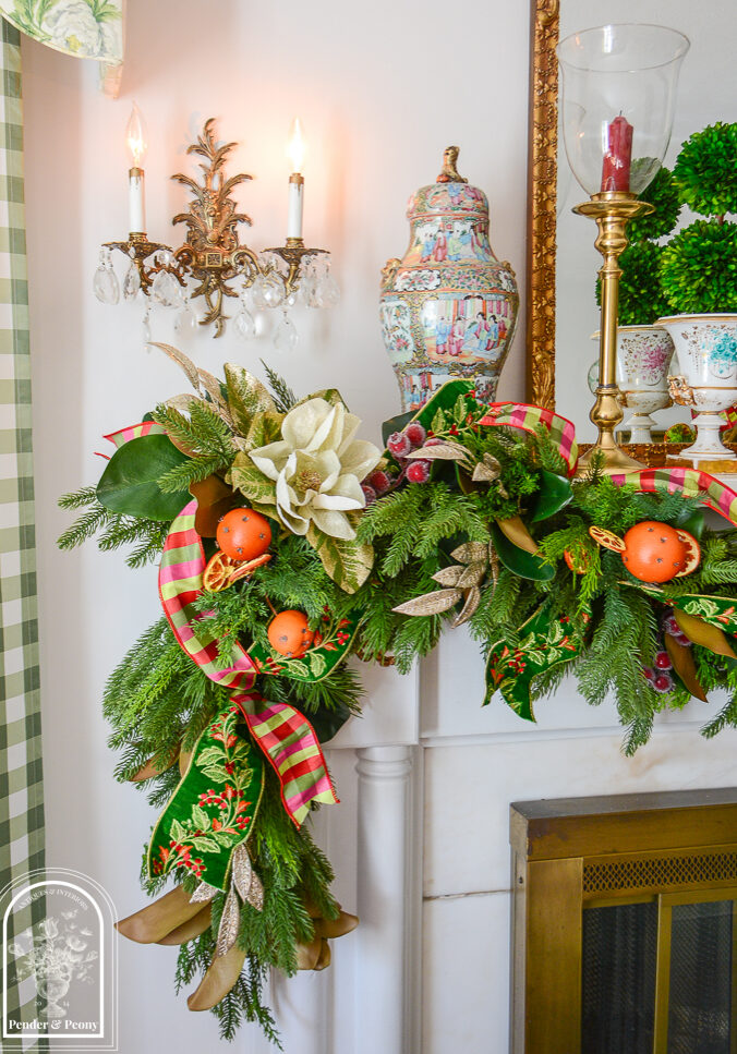 Glittered magnolia and laurel sparkle on this 2026 Christmas garland idea that blends traditional Colonial Williamsburg style with that Old World Christmas feel.