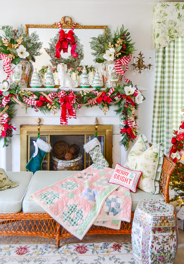 Katherine's formal living room mantel decorated with jolly blossoms Christmas decor: magnolia, holly, pink velvet, red gingham, Rose Medallion