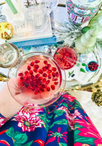 Top view of coupe filled with pomegranate gin cocktail for the holidays